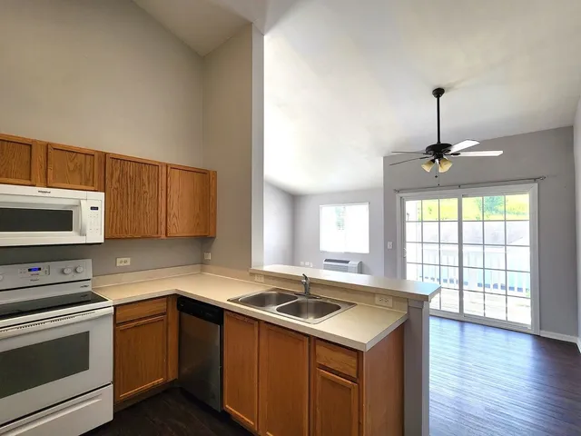 a kitchen with a stove a sink and a microwave