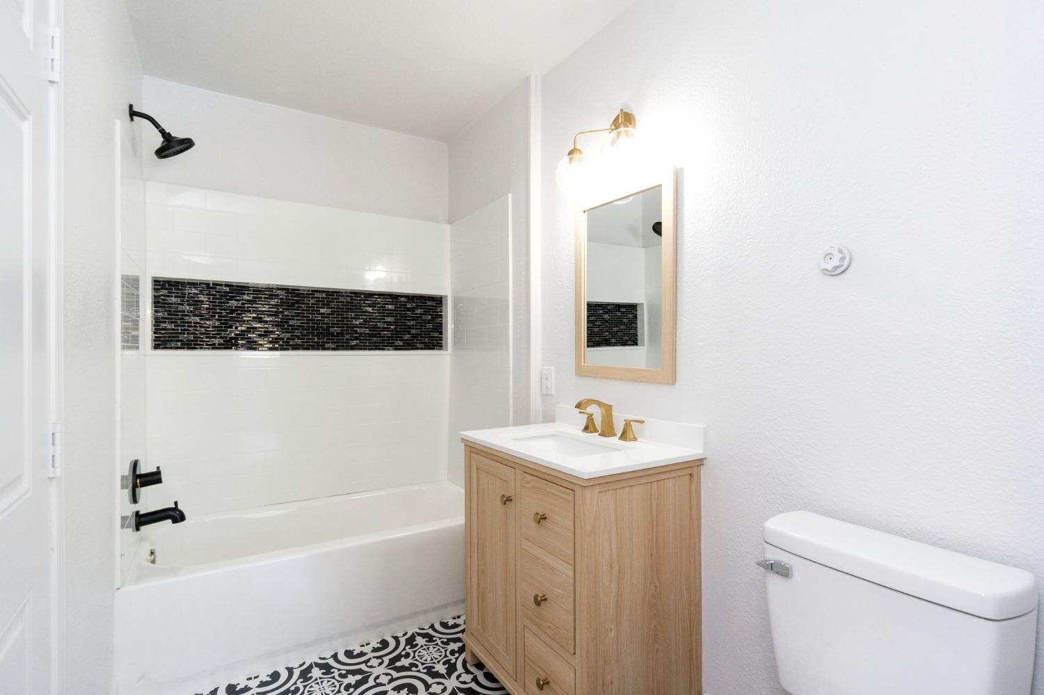 3086 West Hampton Way Fresno, CA 93722 - Photo 26 of 33 a bathroom with a sink a toilet and shower