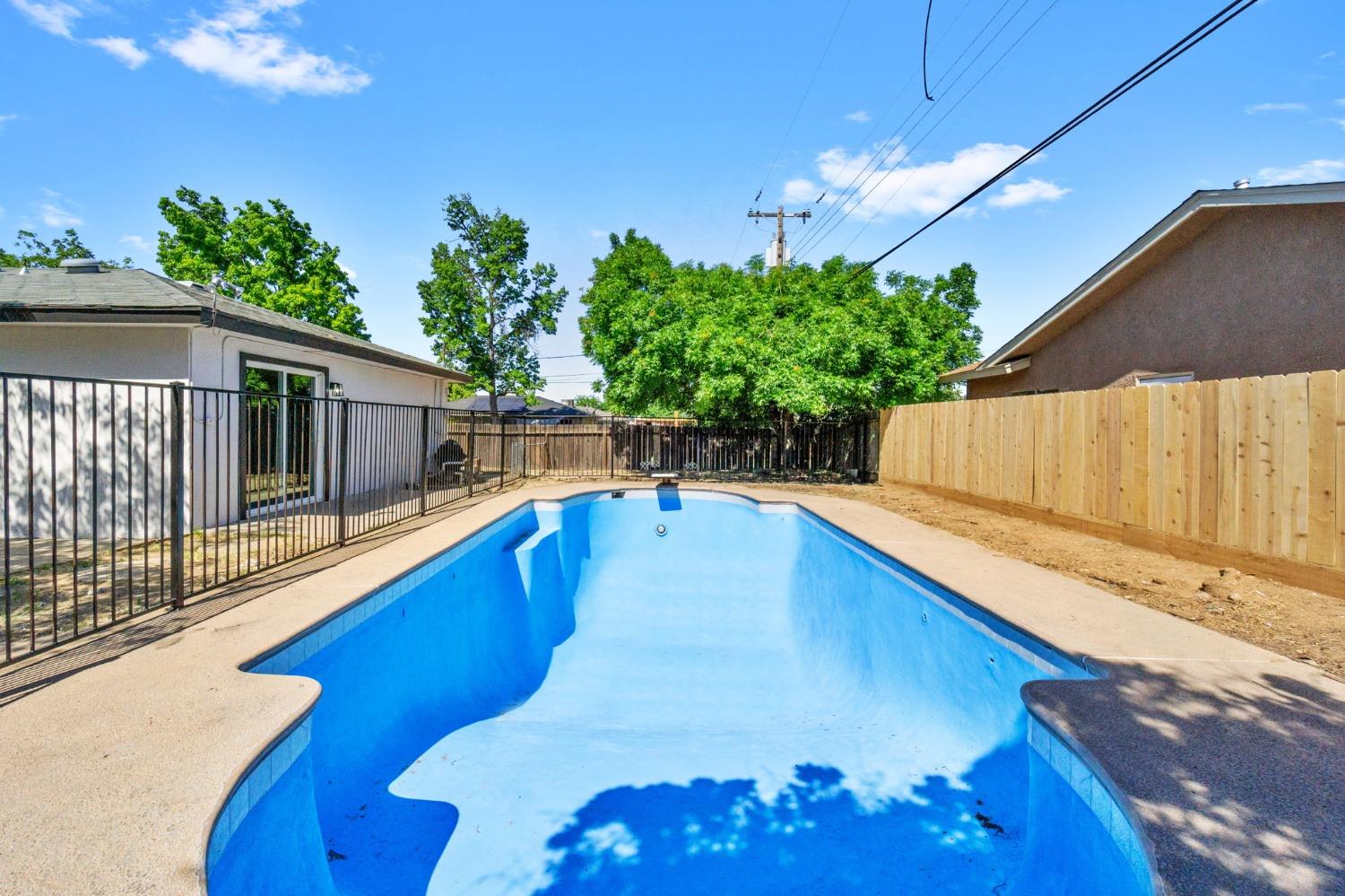 3086 West Hampton Way Fresno, CA 93722 - Photo 28 of 33 a view of a backyard with plants and a patio
