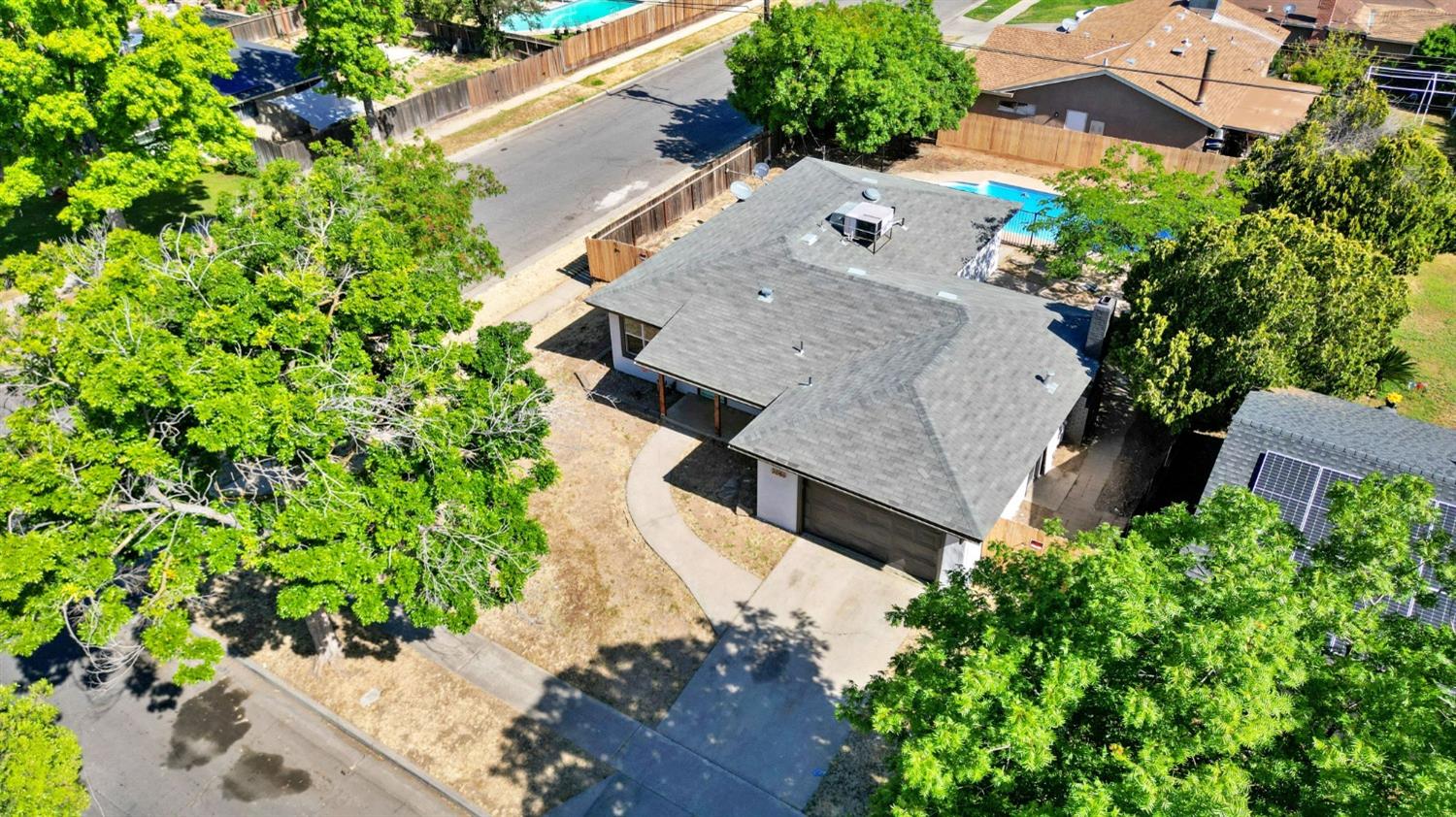 3086 West Hampton Way Fresno, CA 93722 - Photo 29 of 33 an aerial view of residential house with outdoor space and trees all around
