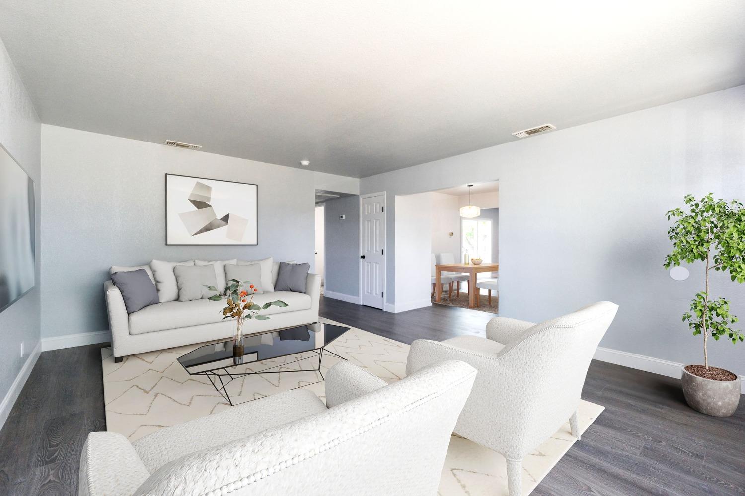 3086 West Hampton Way Fresno, CA 93722 - Photo 7 of 33 a living room with furniture and wooden floor
