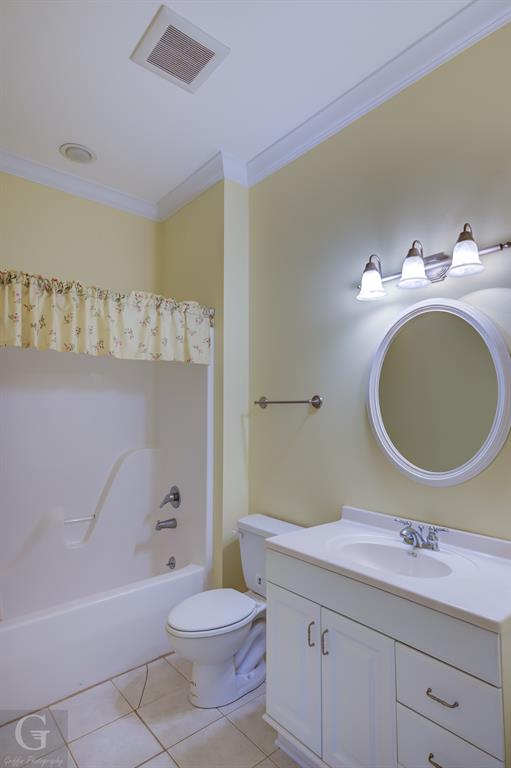 1212 WPA Road Homer, LA 71040 - Photo 15 of 35 Full bath featuring ornamental molding, tile patterned flooring, toilet, a tub to relax in, and vanity