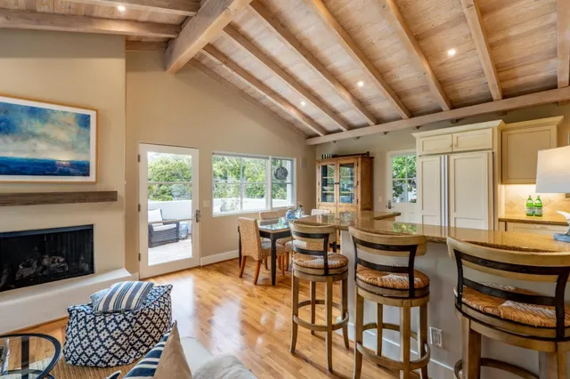 a dining room with furniture a fireplace and wooden floor