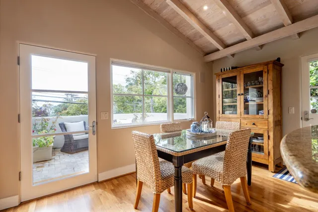 a dining room with furniture window and wooden floor
