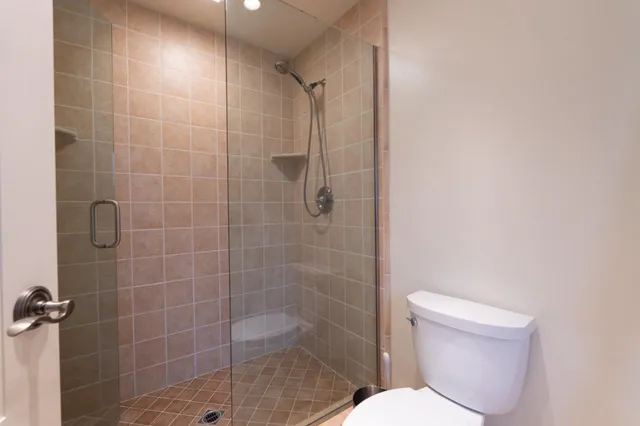 a bathroom with a toilet and shower
