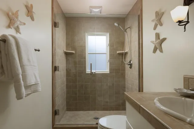 a bathroom with a sink toilet and shower