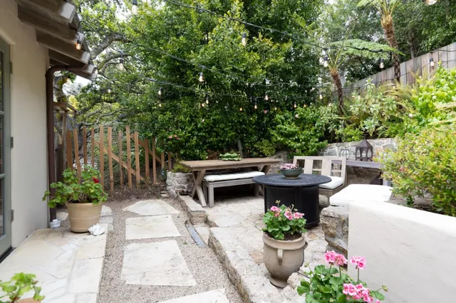 a view of a balcony with outdoor seating and plants