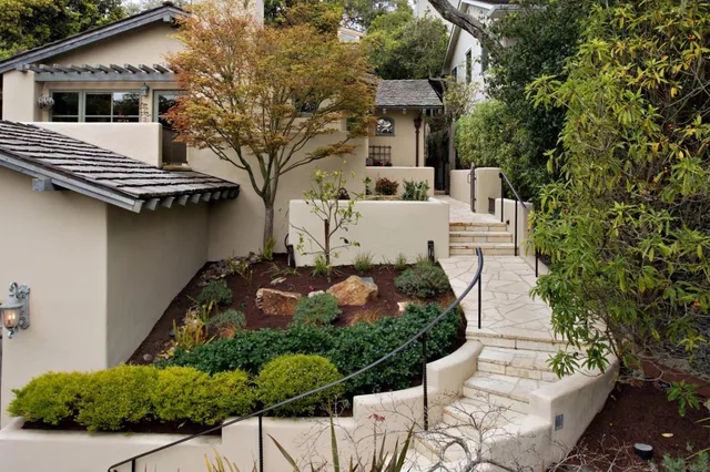 a view of a white house with large windows