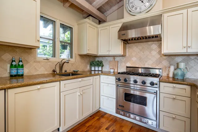 a kitchen with cabinets appliances and a window