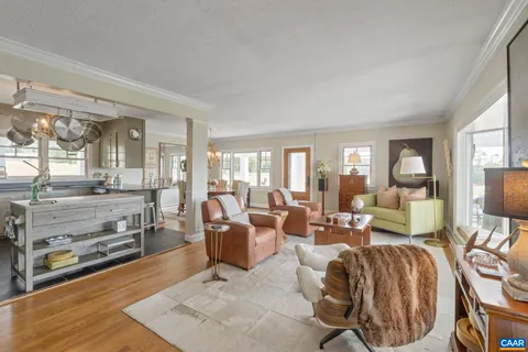 a living room with furniture a fireplace and a large window
