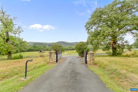 a view of a porch with furniture and a yard