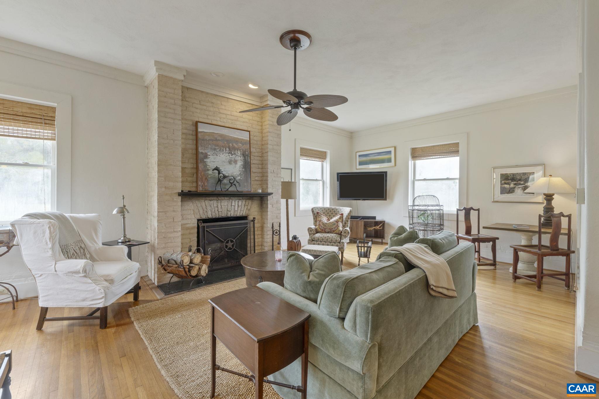 12189 Norwood Road Wingina, VA 24599 - Photo 37 of 75 a living room with furniture a fireplace and a flat screen tv
