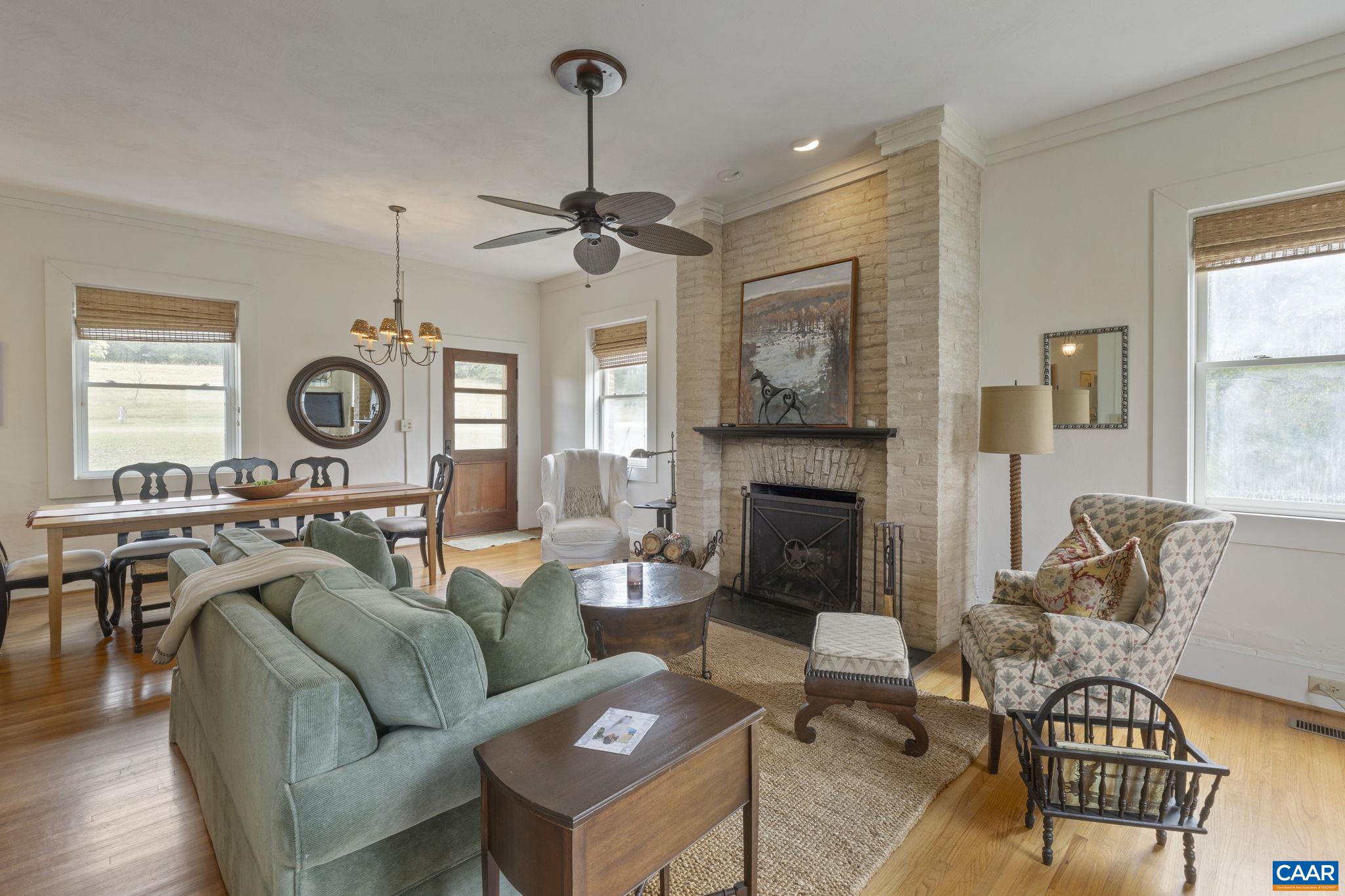 12189 Norwood Road Wingina, VA 24599 - Photo 38 of 75 a living room with furniture a fireplace and a large window