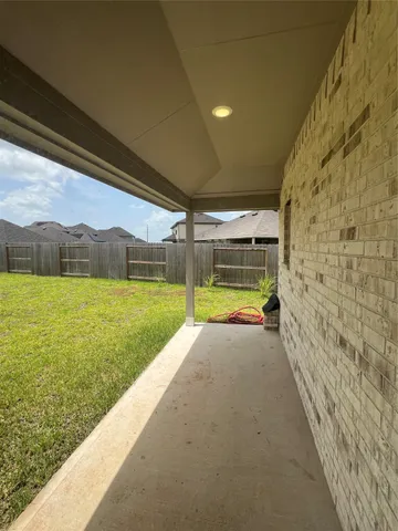 a view of swimming pool with yard in front of it