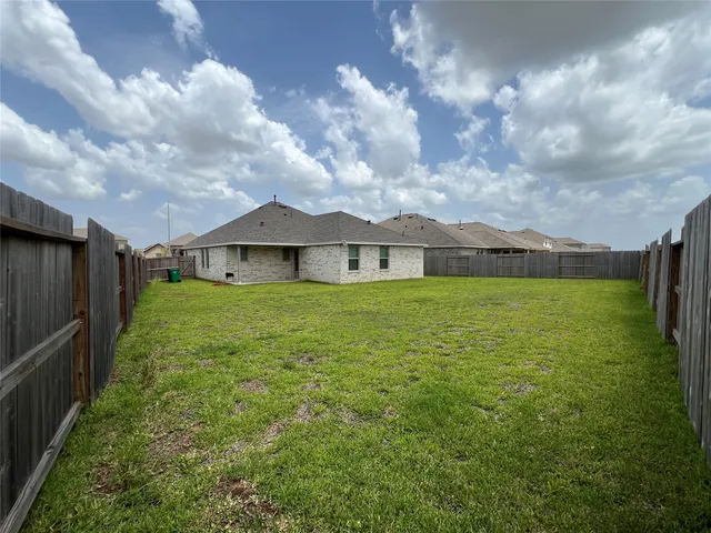 a view of a house with a yard and sitting area