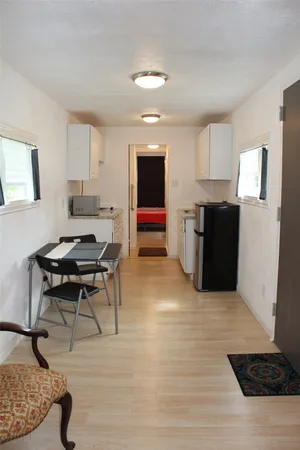 a living room with furniture and a rug