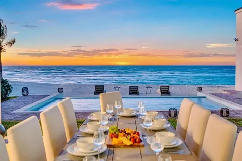 a view of a dining room with furniture a rug and wooden floor
