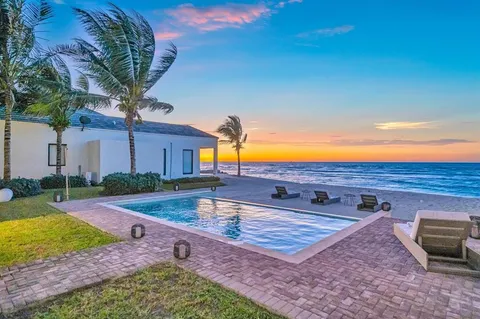 a view of a backyard with swimming pool