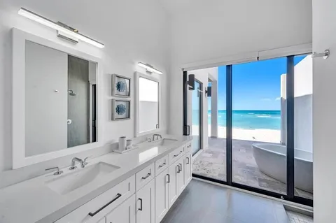 a spacious bathroom with a double vanity sink and a mirror