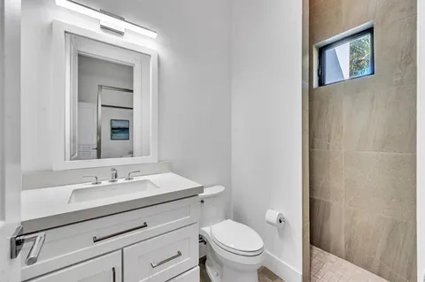 a bathroom with a sink toilet and vanity