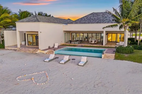 a view of a house with backyard porch and sitting area