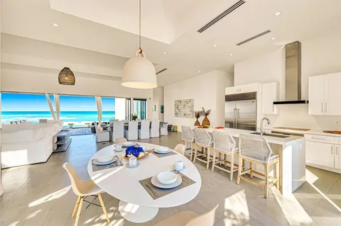 a living room with lots of furniture and kitchen view