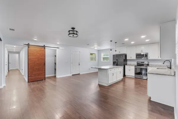 a view of kitchen with furniture and wooden floor