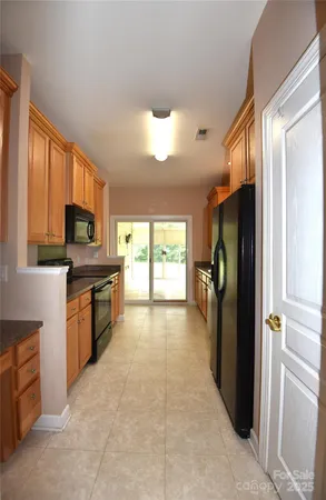 a kitchen with stainless steel appliances granite countertop a refrigerator stove top oven a sink and dishwasher