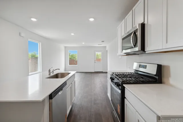 a kitchen that has a sink and a stove