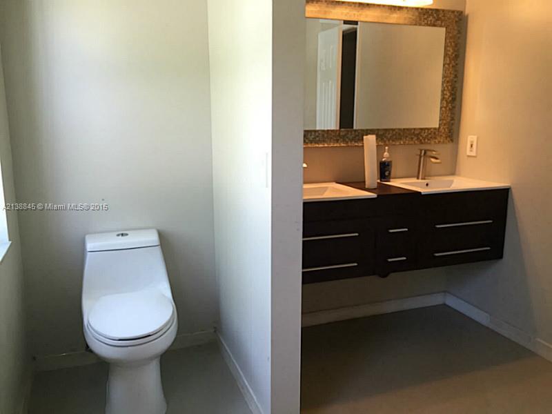 13674 Southwest 124th Avenue Road Miami, FL 33186 - Photo 11 of 21 a bathroom with a toilet sink and mirror