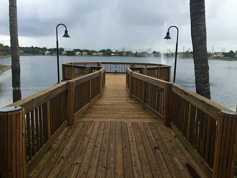 13674 Southwest 124th Avenue Road Miami, FL 33186 - Photo 20 of 21 a view of a balcony with wooden floor and iron stairs