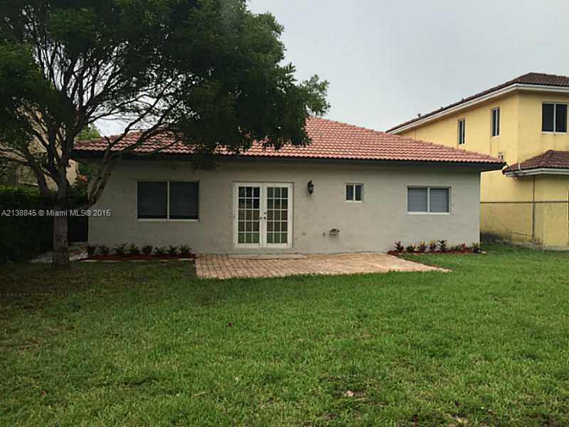 13674 Southwest 124th Avenue Road Miami, FL 33186 - Photo 2 of 21 a front view of a house with a garden