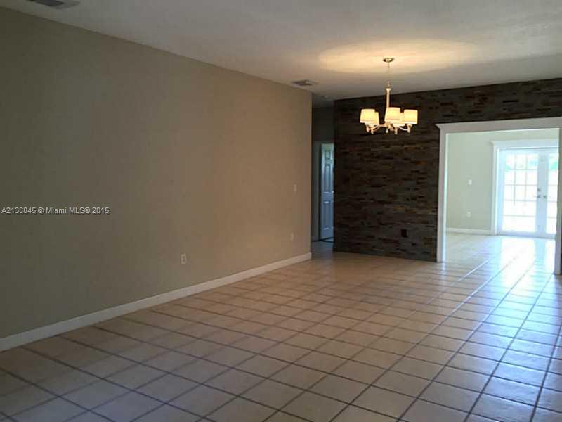 13674 Southwest 124th Avenue Road Miami, FL 33186 - Photo 5 of 21 an empty room with wooden floor
