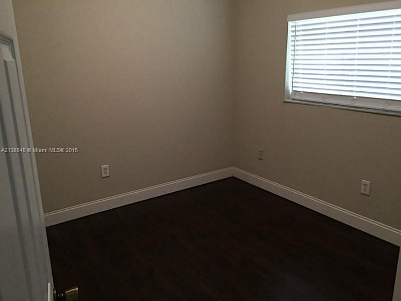 13674 Southwest 124th Avenue Road Miami, FL 33186 - Photo 9 of 21 a view of a small space with wooden floor and a window