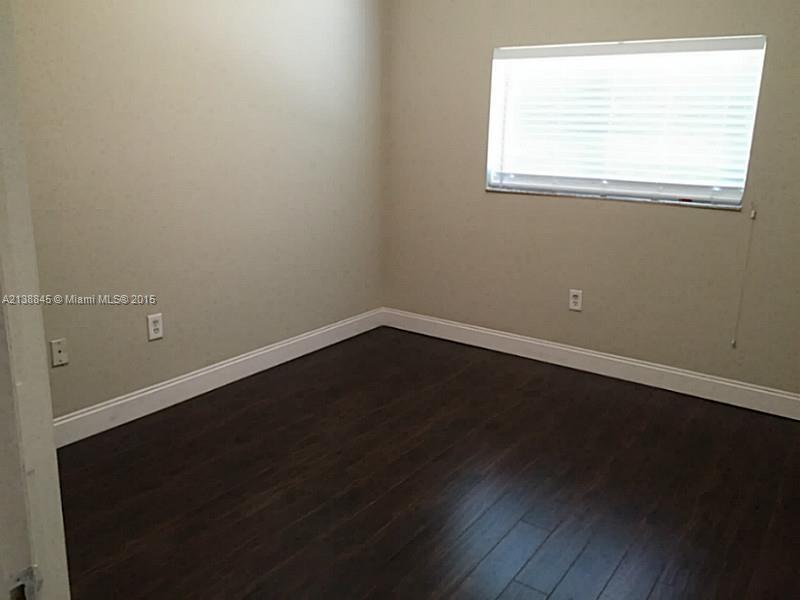 13674 Southwest 124th Avenue Road Miami, FL 33186 - Photo 10 of 21 an empty room with wooden floor and windows