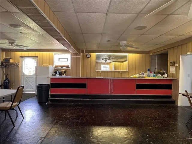 a room with furniture pool table table and a window