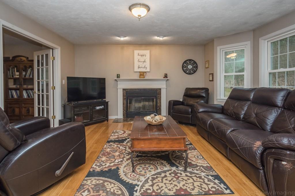 41 Tannery Road Sturbridge, MA 01518 - Photo 13 of 42 a living room with furniture a flat screen tv and a fireplace