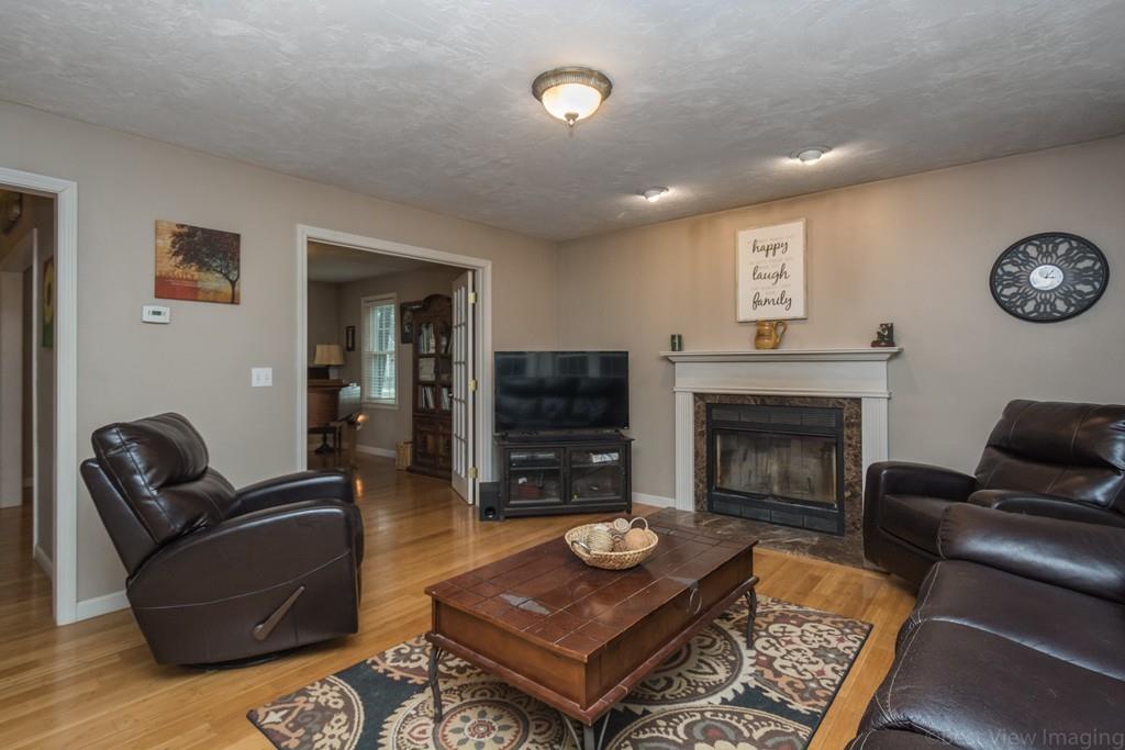 41 Tannery Road Sturbridge, MA 01518 - Photo 15 of 42 a living room with furniture a flat screen tv and a fireplace