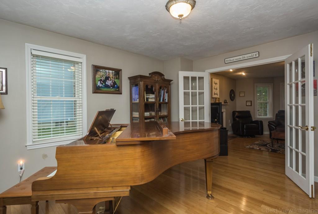 41 Tannery Road Sturbridge, MA 01518 - Photo 23 of 42 a living room with furniture a flat screen tv and large window