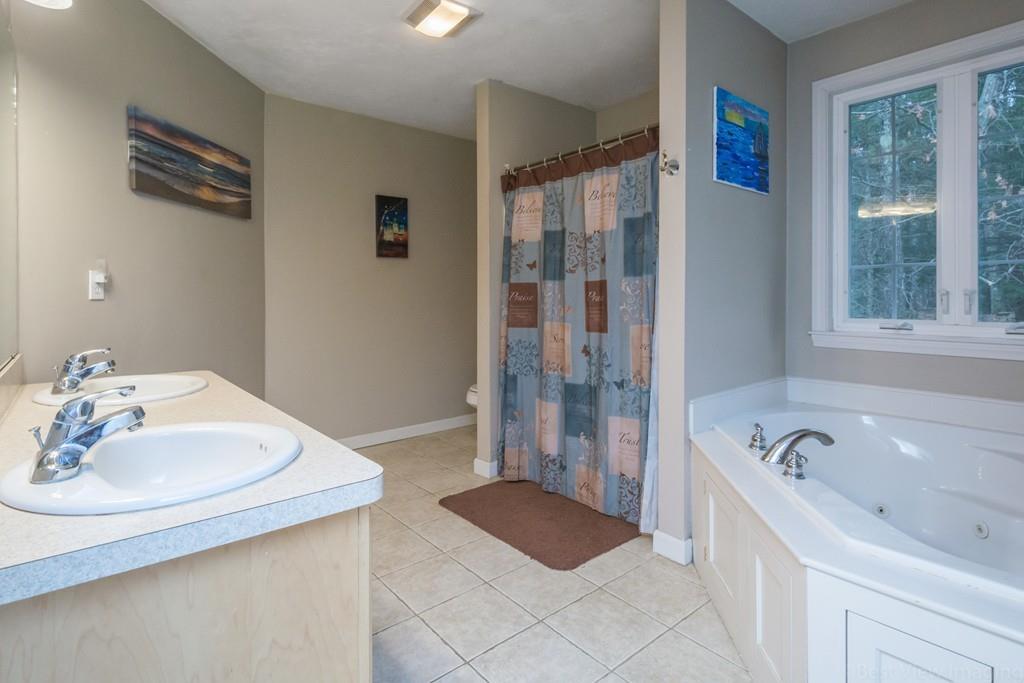 41 Tannery Road Sturbridge, MA 01518 - Photo 30 of 42 a bathroom with a tub sink and mirror