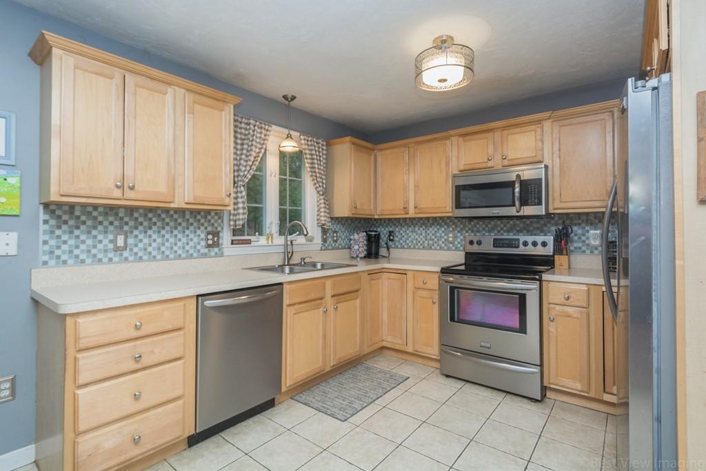 41 Tannery Road Sturbridge, MA 01518 - Photo 7 of 42 a kitchen with stainless steel appliances granite countertop a sink and cabinets