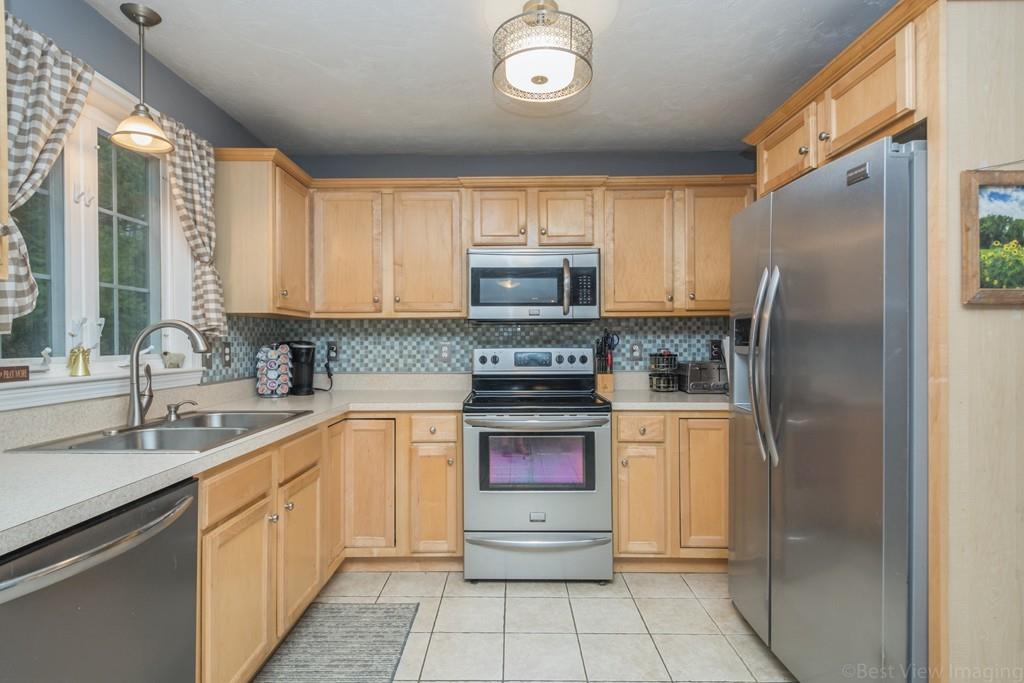 41 Tannery Road Sturbridge, MA 01518 - Photo 9 of 42 a kitchen with stainless steel appliances granite countertop a refrigerator sink and stove