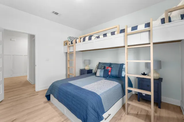 a bedroom with a bed a table and closet