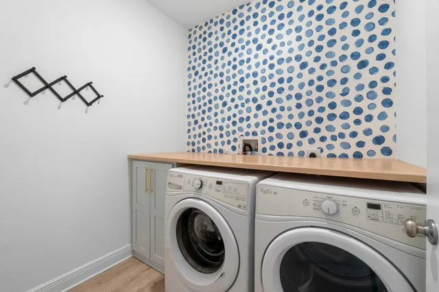a utility room with dryer washer and empty racks