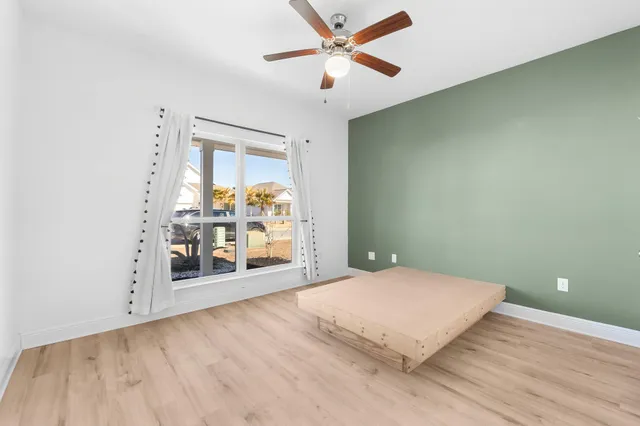 a view of a livingroom with a ceiling fan and window