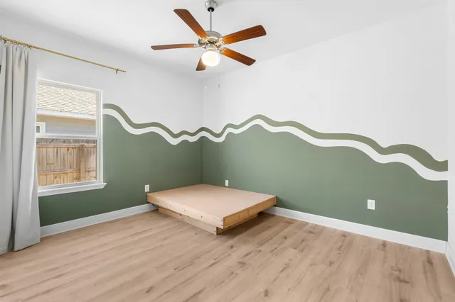 a bedroom with a bed and window