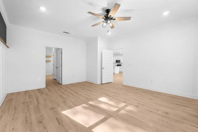 a view of empty room with wooden floor