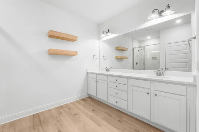 a bathroom with a sink vanity and mirror