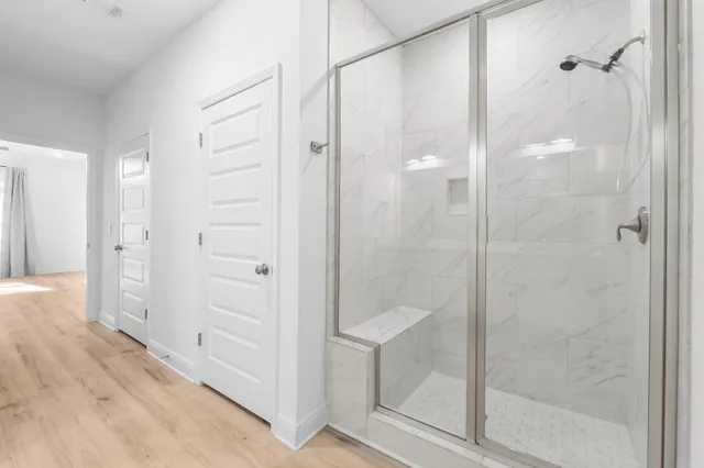 a bathroom with a shower and a glass door