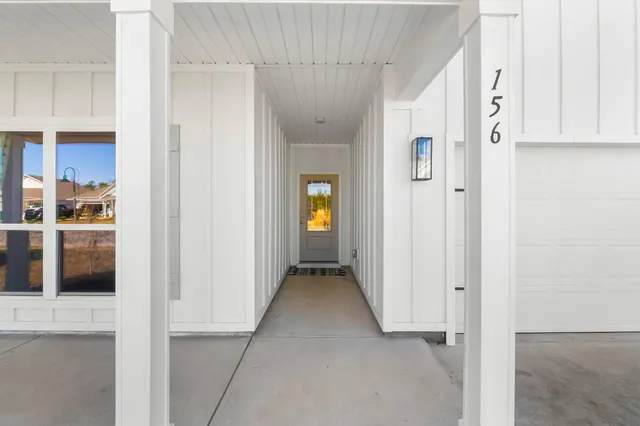 a view of a hallway with wooden shelves